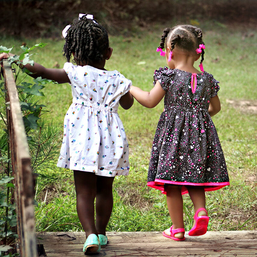 2-girl-walking-on-brown-bridge-during-daytime-50581